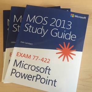A Stack of microsoft office exams study guide text books.