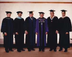 University of Portland President and senior administrators all wearing academic regalia.