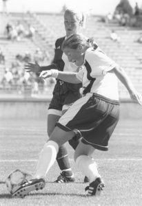 Michelle French controls the soccer ball with her left foot.