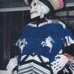 Decorated skeleton wearing poncho and sombrero.