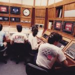 Television studio control room with operators at the controls.