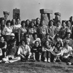 Group of college students posed in front of Stonehenge.