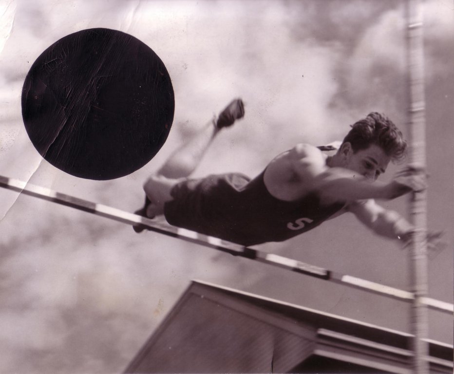 Jerry Studley clearing a pole vault bar.