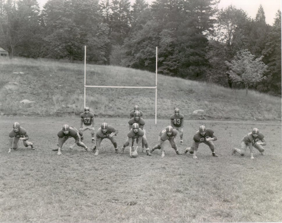 Football players setting up for their offensive position.