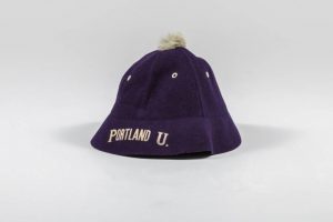 purple beanie cap with white pom