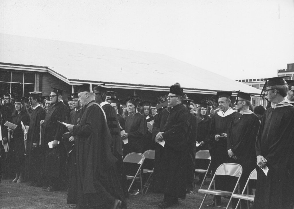 Academic procession for an outdoor commencement ceremony.