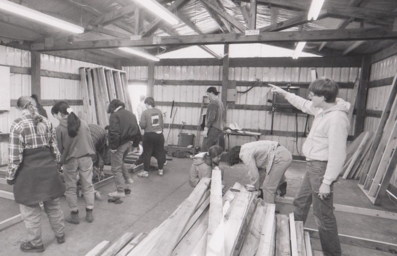 Group of volunteer students building a barn.