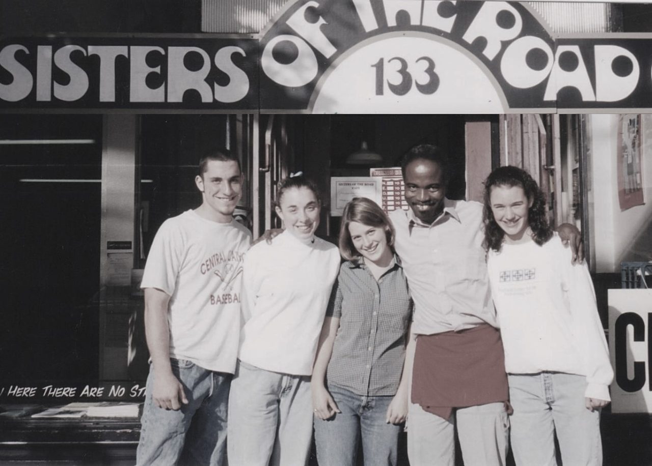 Five people standing in front of Sisters of the Road cafe.