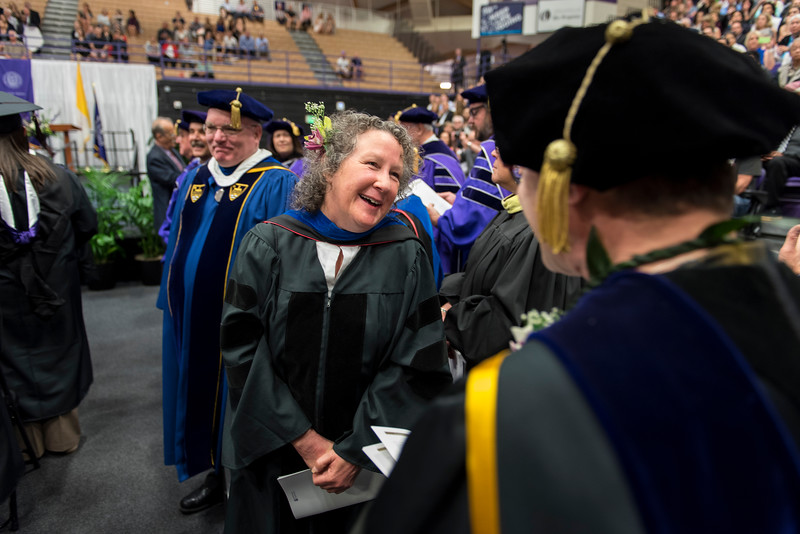 Doctor Sally Hood smiling and wearing academic regalia.