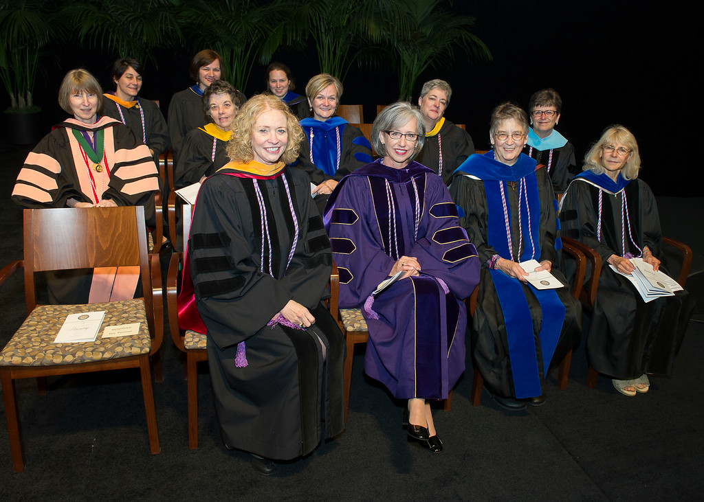 Nursing Faculty in academic regalia seated in chairs.