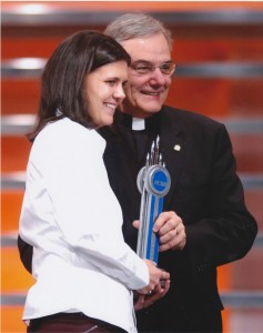 Rev. E. William Beauchamp, C.S.C. with Christine Sinclair ’06; in 2006 receiving the NCAA "Top VIII" Award 2006; top female collegiate soccer player 2006 (University Archives photo)