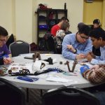 Faculty and Students working on building a prosthetic hand
