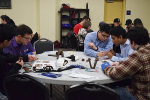 Faculty and Students working on building a prosthetic hand