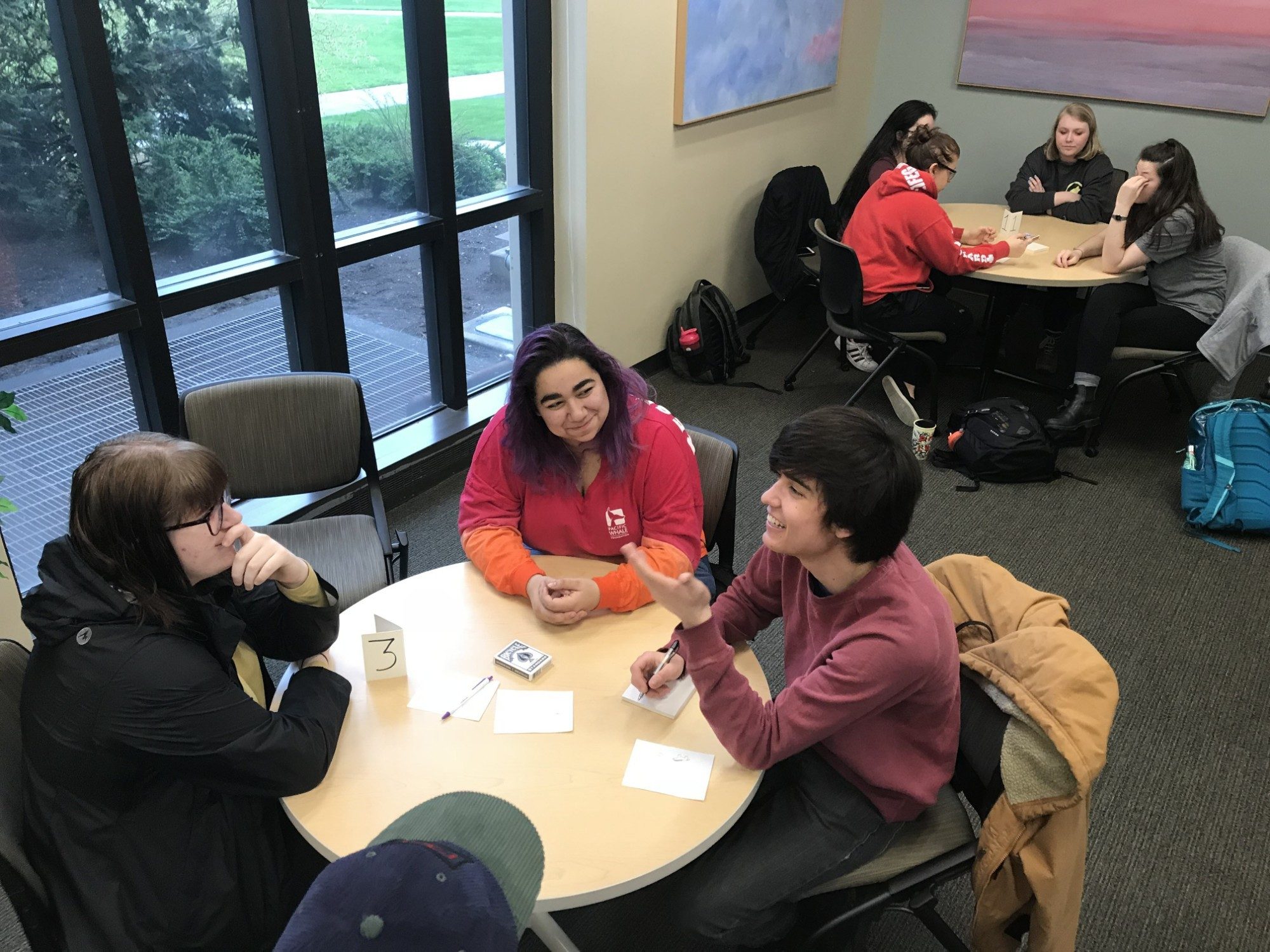 students sitting around a table in the tutoring center